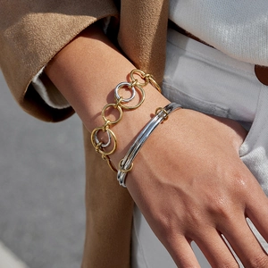 Two-tone mixed metal chain bracelet and open bangle in 18k gold and silver finish