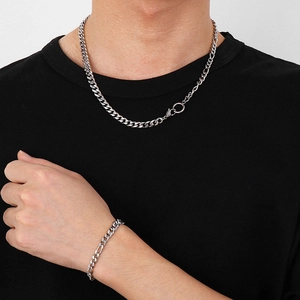Classic silver stainless steel Figaro chain necklace and bracelet set for men on model