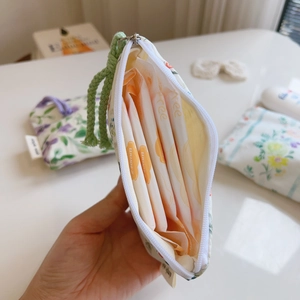 Close-up of floral cotton pouch interior showing capacity for sanitary pads storage