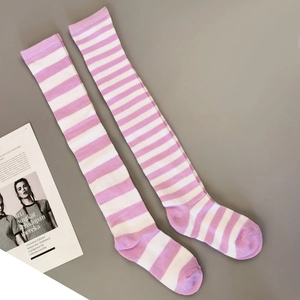 Flat lay detail of pink and white striped cotton thigh-high socks on a grey surface