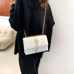 White quilted PU leather crossbody bag with gold chain strap and SS logo tassel charm