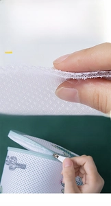 Detailed view of sandwich mesh fabric and auto-lock zipper on printed laundry bag