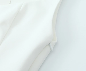 Detail of the high-quality white stretch top featuring a concealed side zipper closure