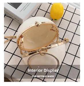 Detail view of the pearl-white spherical evening bag interior with gold metal frame
