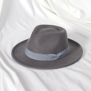 Detailed view of teardrop crown and silk ribbon on vintage grey wool fedora hat