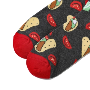 Detailed close-up of grey knit socks featuring taco patterns and reinforced red toes