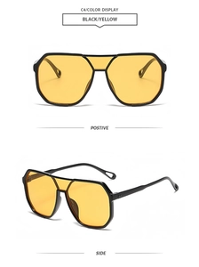 Detail of pilot-style sunglasses with black frames, yellow lenses and teardrop cutouts