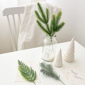 Artificial pine branches in green and grey tones for DIY Christmas floral decorations