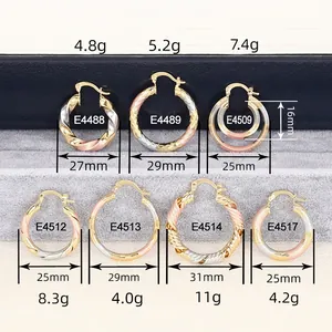 Assorted gold and silver metal hoop earrings in various sizes and twisted textures