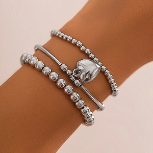 Three-piece silver bead bracelet set with heart pendant charm for a trendy aesthetic