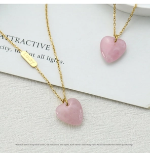 Detail of pink crystal heart pendant with gold Lucky tag on 18K gold plated necklace