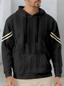 Detail of men's black knit hoodie with textured jacquard and white stripes on sleeves