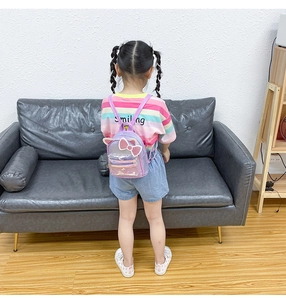 Rear view of a child wearing the purple sequin cat ear backpack with bow detail