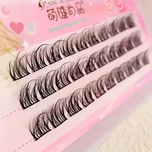 5D tiered faux mink eyelash clusters with natural curl and thin black roots on pink background