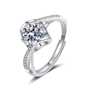 Macro shot of silver ring featuring heart-shaped hollow design and bright zircon stone