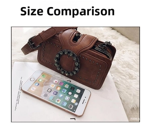 Brown vintage rivet bag size comparison with an iPhone on a plush white background