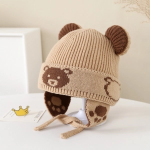 Detailed knit of winter earflap hat with bear ear design and soft chin straps