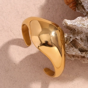 Macro shot of minimalist polished 18K gold-plated stainless steel cuff bracelet