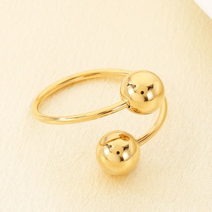 Detailed macro shot of 18k gold plated stainless steel ring with double ball design