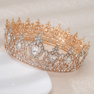 Close-up of luxury bridal crown featuring AB crystals and gold metal work on display