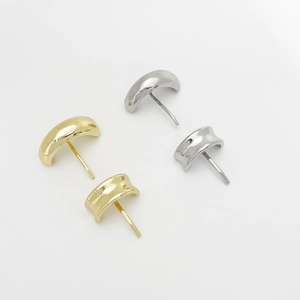 Close-up of gold and silver alloy stud earrings set on a clean white background