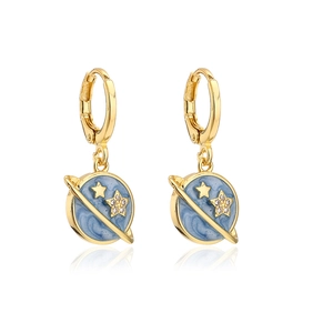 Detailed close-up of planet-shaped gold earrings with blue enamel and zircon stars