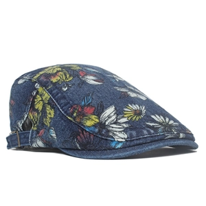 Detail of floral denim beret with adjustable metal buckle and vibrant peony print