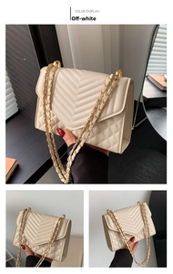 Detail of off-white shoulder bag with V-shaped quilting and golden chain strap