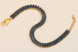 Detailed close-up of 18K gold plated bracelet with rectangular deep blue crystals