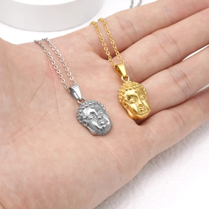 18K gold and silver stainless steel Buddha head pendant necklaces shown on palm