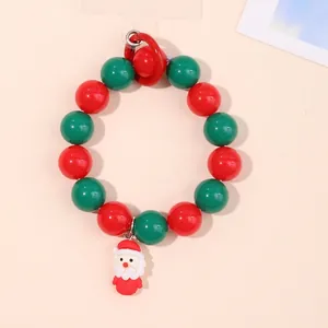 Christmas beaded wrist strap with Santa Claus charm in festive red and green colors