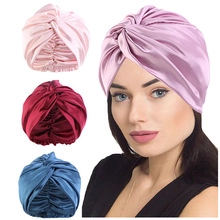 Detailed view of braided satin turbans in pink, burgundy, blue, and light purple shades