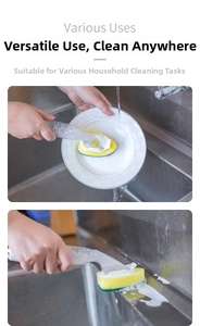Detail of dual-layer sponge dish brush cleaning a white ceramic plate and metal sink edge