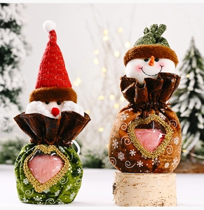 Close-up of Santa and snowman Christmas candy bags with transparent heart window and drawstrings