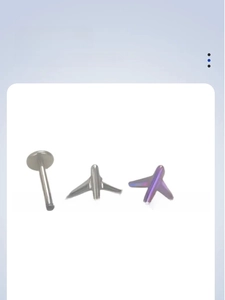 Macro detail of G23 titanium airplane stud earrings with internal thread and purple finish