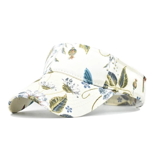 Detailed close-up of white sun visor with green floral print and wide curved brim