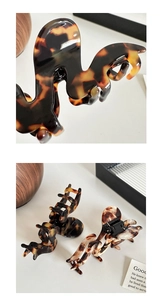Detailed close-up of 3mm thick leopard print and tortoise shell wavy acetate hair claws