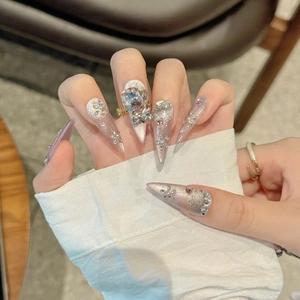 Luxurious peach pink stiletto press-on nails with 3D crystals and metal chain detail