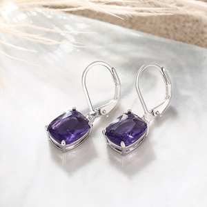 Macro shot of rectangular purple gemstone earrings with silver lever-back hooks