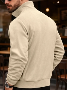 Detail of men's beige corduroy hoodie showing vertical ribbed texture and high collar