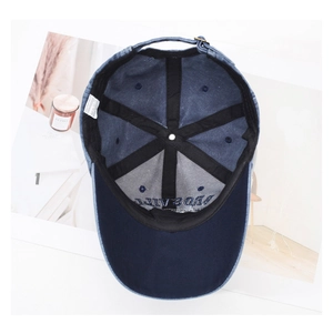 Detail view of washed navy cotton baseball cap interior with 100% cotton label and sweatband