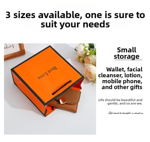 Detail view of orange gift bag with Best Love text and black handle for small wallet storage