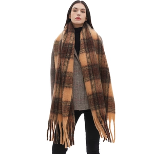 Thick brown plaid shawl scarf with tassels worn by model on white background