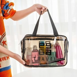 Detailed view of large PVC travel cosmetic bag with black handle and TRAVEL logo