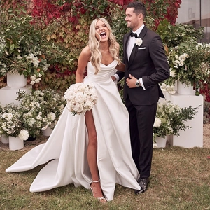 Minimalist white satin strapless wedding dress with high slit and elegant long train