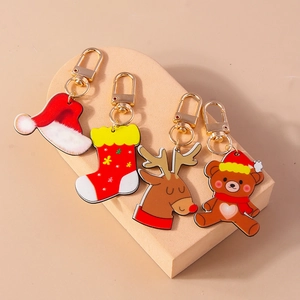 Set of four Christmas acrylic keychains featuring Santa hat, sock, reindeer, and bear icons