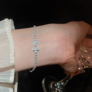 Sparkling zircon bowknot pendant bracelet worn on wrist with elegant lighting effect