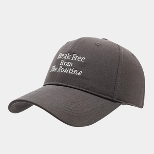 Detail of dark grey cotton baseball cap featuring white 3D letter embroidery