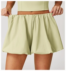 Detailed texture of light green bubble shorts with elastic waistband and pleated fabric