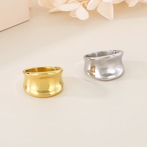 Detailed view of irregular 18K gold and silver plated wide band rings in polished finish